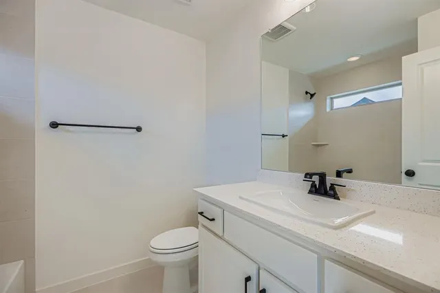 a bathroom with a sink toilet and mirror