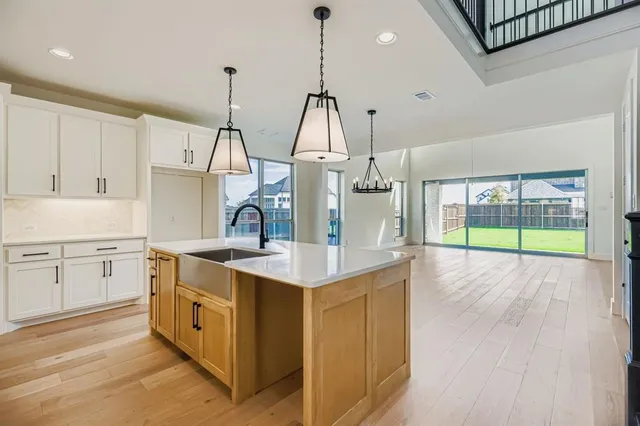 a open kitchen with sink and cabinets