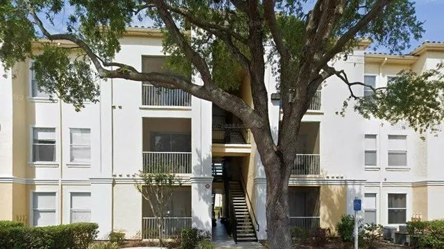 a view of a large building with large trees
