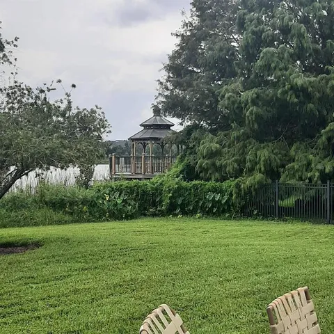 a view of front of house with yard and swimming pool