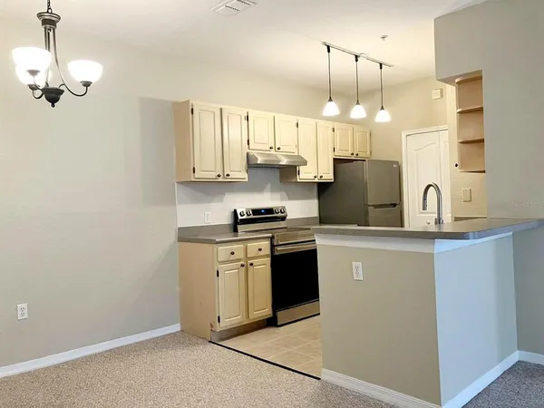 a kitchen with stainless steel appliances granite countertop a sink a stove and a refrigerator