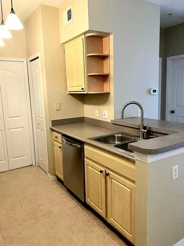 a kitchen with a sink cabinets and appliances