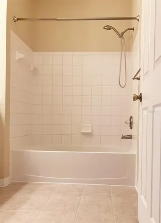 a bathroom with a shower and a bath tub