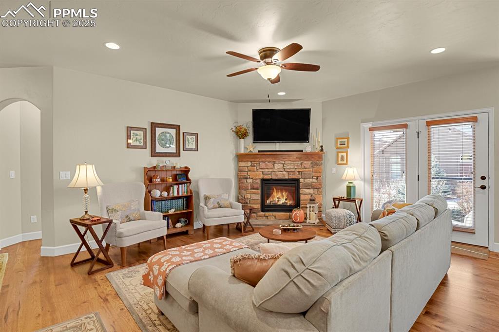13015 Cake Bread Heights Colorado Springs, CO 80921 - Photo 11 of 45 a living room with furniture a fireplace and a flat screen tv