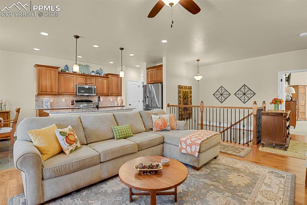 13015 Cake Bread Heights Colorado Springs, CO 80921 - Photo 12 of 45 a living room with furniture and kitchen view