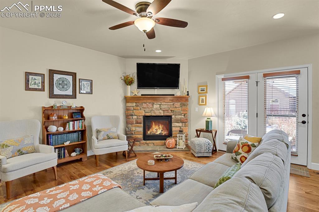 13015 Cake Bread Heights Colorado Springs, CO 80921 - Photo 13 of 45 a living room with furniture a flat screen tv and a fireplace