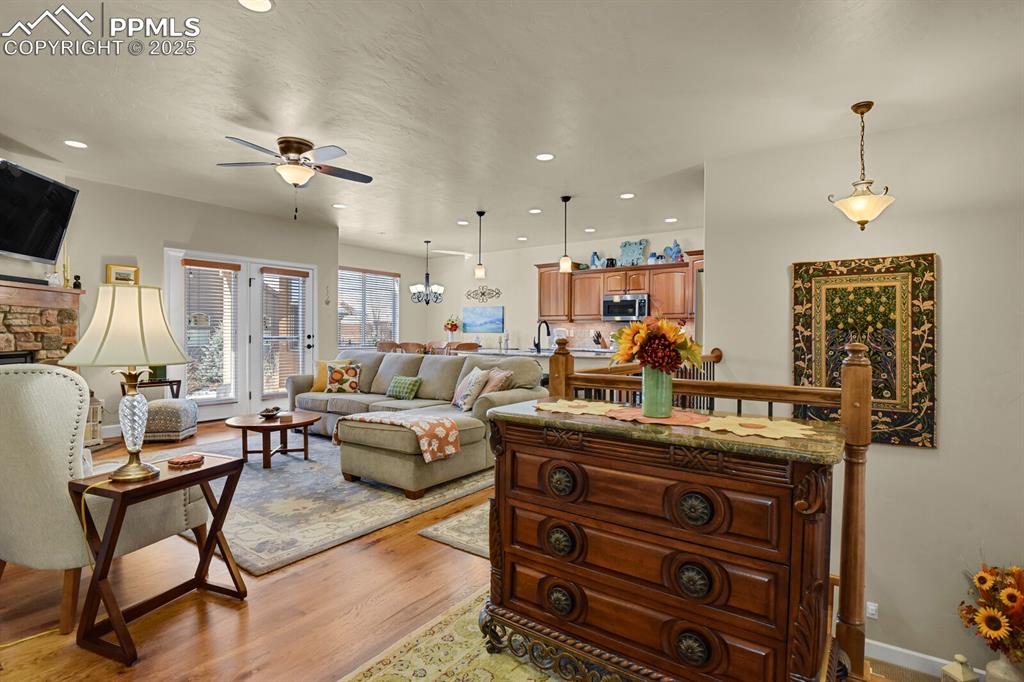 13015 Cake Bread Heights Colorado Springs, CO 80921 - Photo 15 of 45 a living room with furniture and a chandelier
