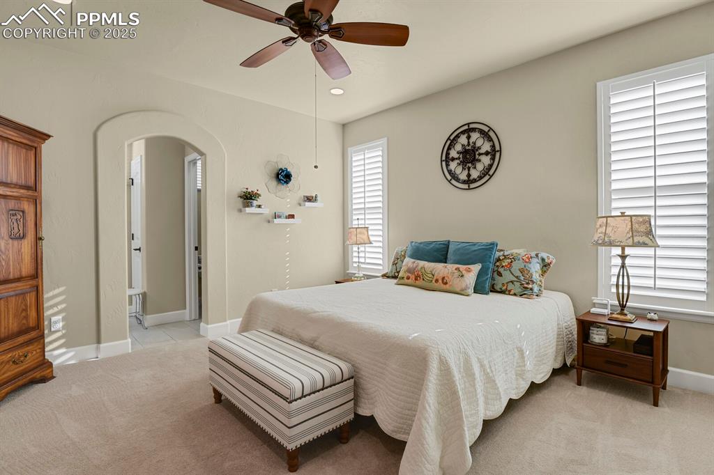 13015 Cake Bread Heights Colorado Springs, CO 80921 - Photo 16 of 45 a spacious bedroom with a bed and a chandelier