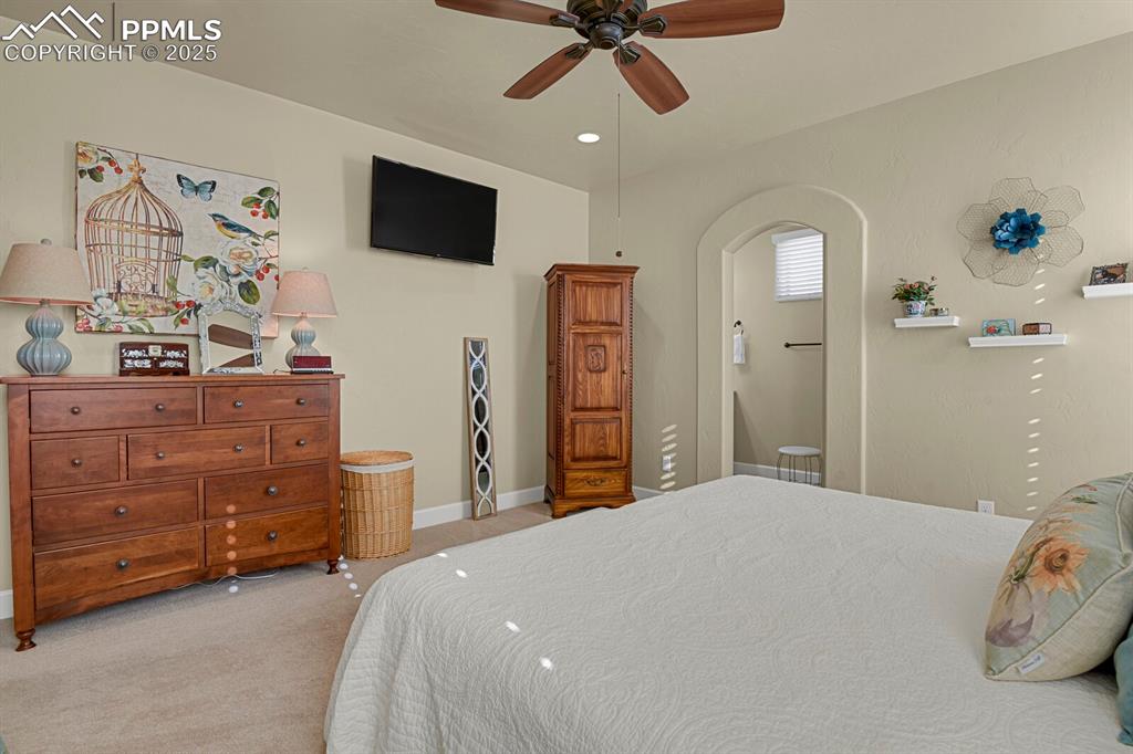 13015 Cake Bread Heights Colorado Springs, CO 80921 - Photo 17 of 45 a bedroom with a bed and a flat tv screen on dresser
