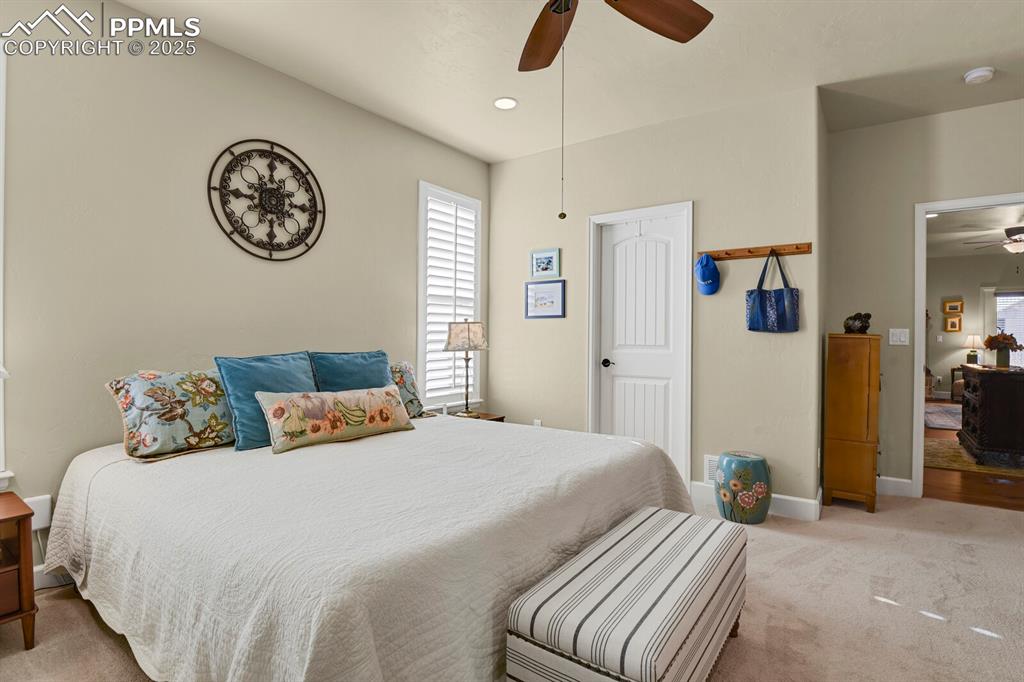 13015 Cake Bread Heights Colorado Springs, CO 80921 - Photo 18 of 45 a bedroom with a bed and a chandelier