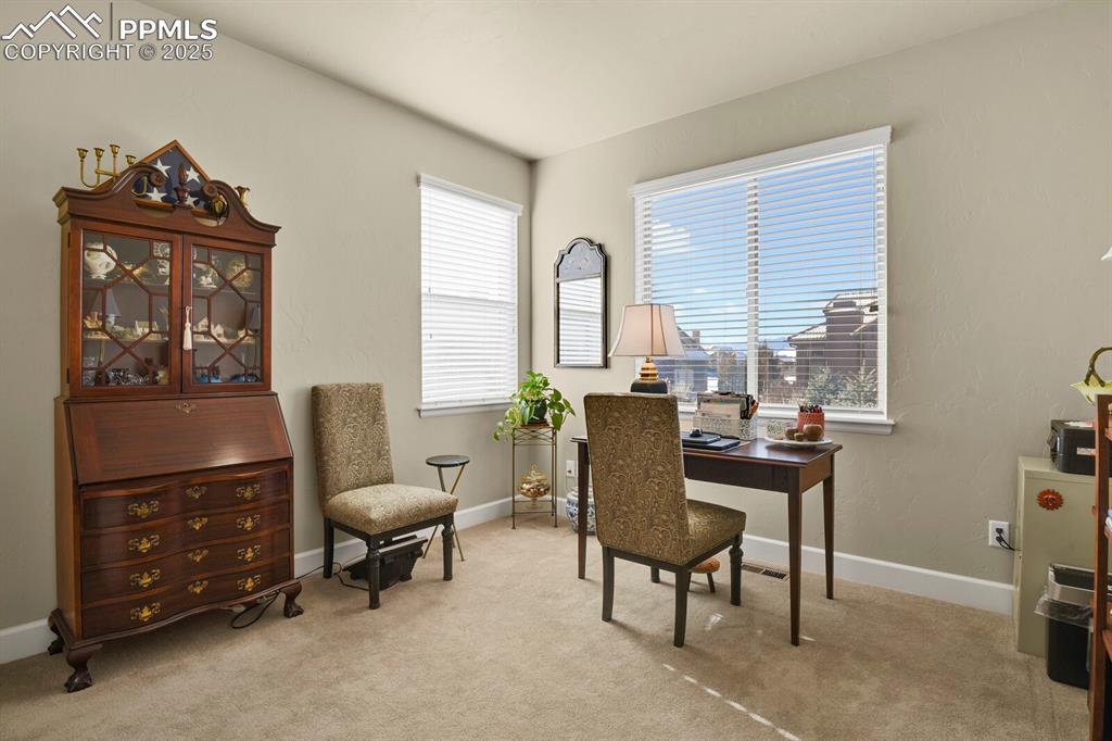 13015 Cake Bread Heights Colorado Springs, CO 80921 - Photo 21 of 45 a view of a workspace with furniture and a window