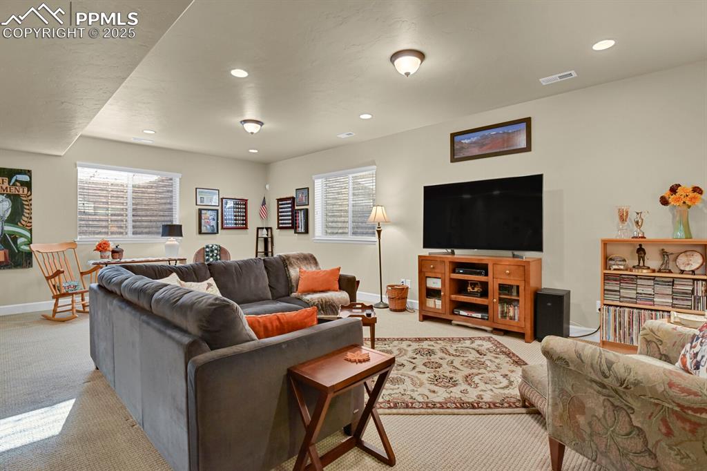 13015 Cake Bread Heights Colorado Springs, CO 80921 - Photo 26 of 45 a living room with furniture and a flat screen tv