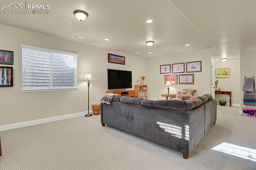 13015 Cake Bread Heights Colorado Springs, CO 80921 - Photo 27 of 45 a living room with furniture and a flat screen tv