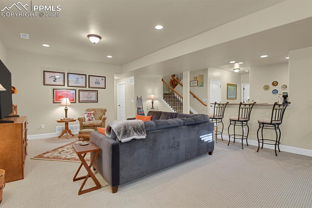 13015 Cake Bread Heights Colorado Springs, CO 80921 - Photo 28 of 45 a living room with furniture and a flat screen tv