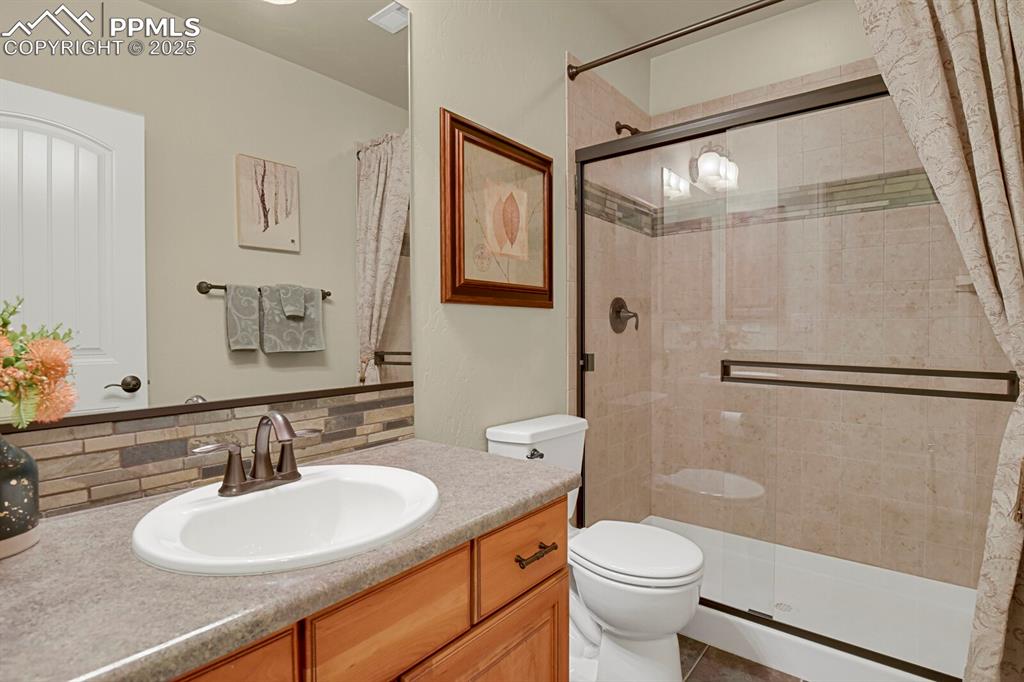13015 Cake Bread Heights Colorado Springs, CO 80921 - Photo 36 of 45 a bathroom with a sink a toilet and a mirror