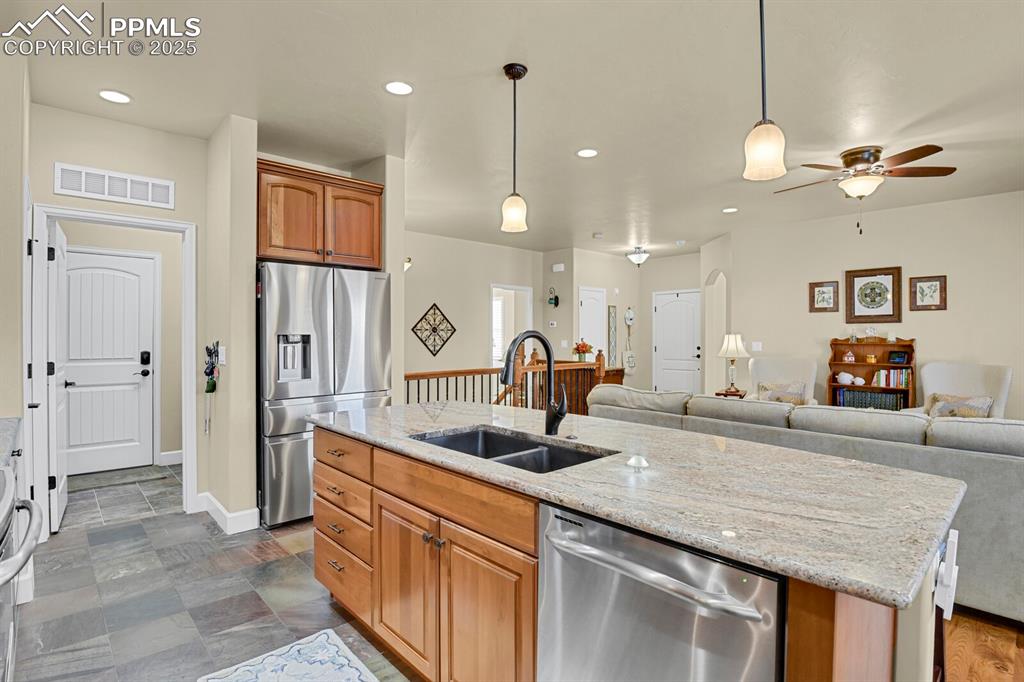 13015 Cake Bread Heights Colorado Springs, CO 80921 - Photo 4 of 45 a kitchen with granite countertop a sink a counter top space and living room view