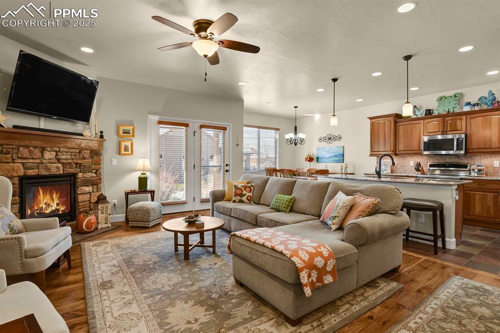 13015 Cake Bread Heights Colorado Springs, CO 80921 - Photo 10 of 45 a living room with fireplace furniture and a flat screen tv