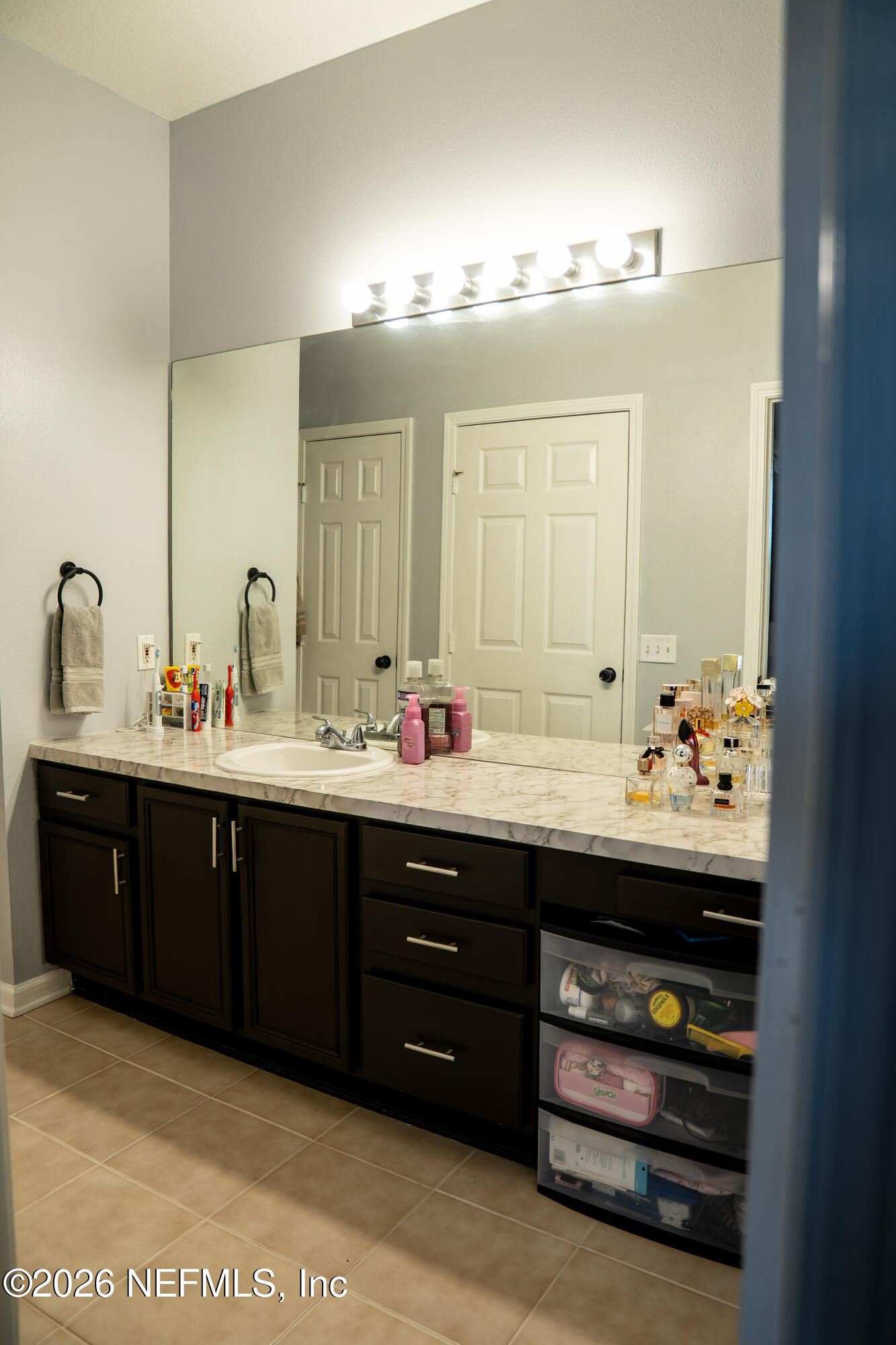 7990 Baymeadows Road East, Unit 530 Jacksonville, FL 32256 - Photo 12 of 19 a bathroom with a sink double vanity and a mirror