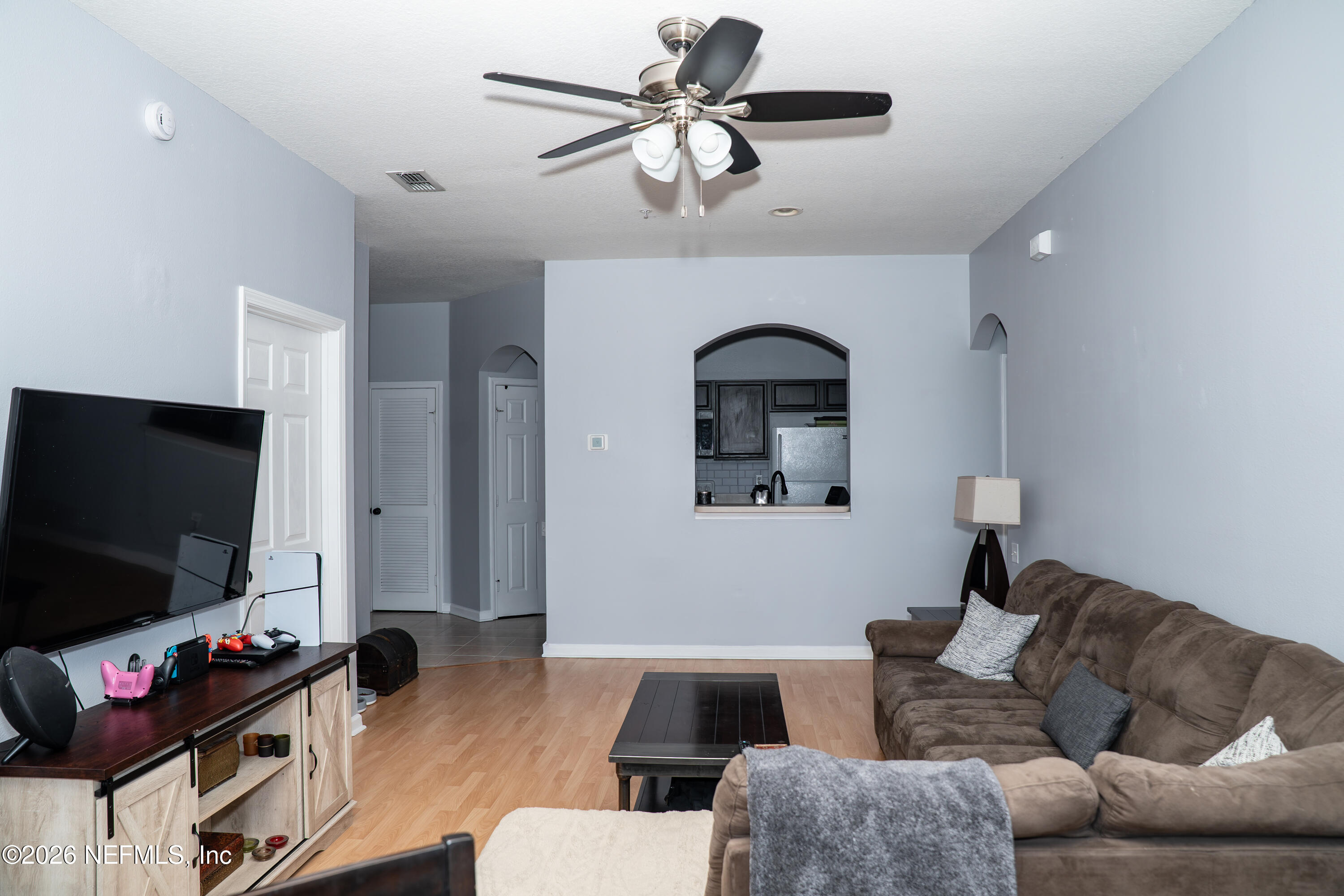 7990 Baymeadows Road East, Unit 530 Jacksonville, FL 32256 - Photo 3 of 19 a living room with furniture and a flat screen tv