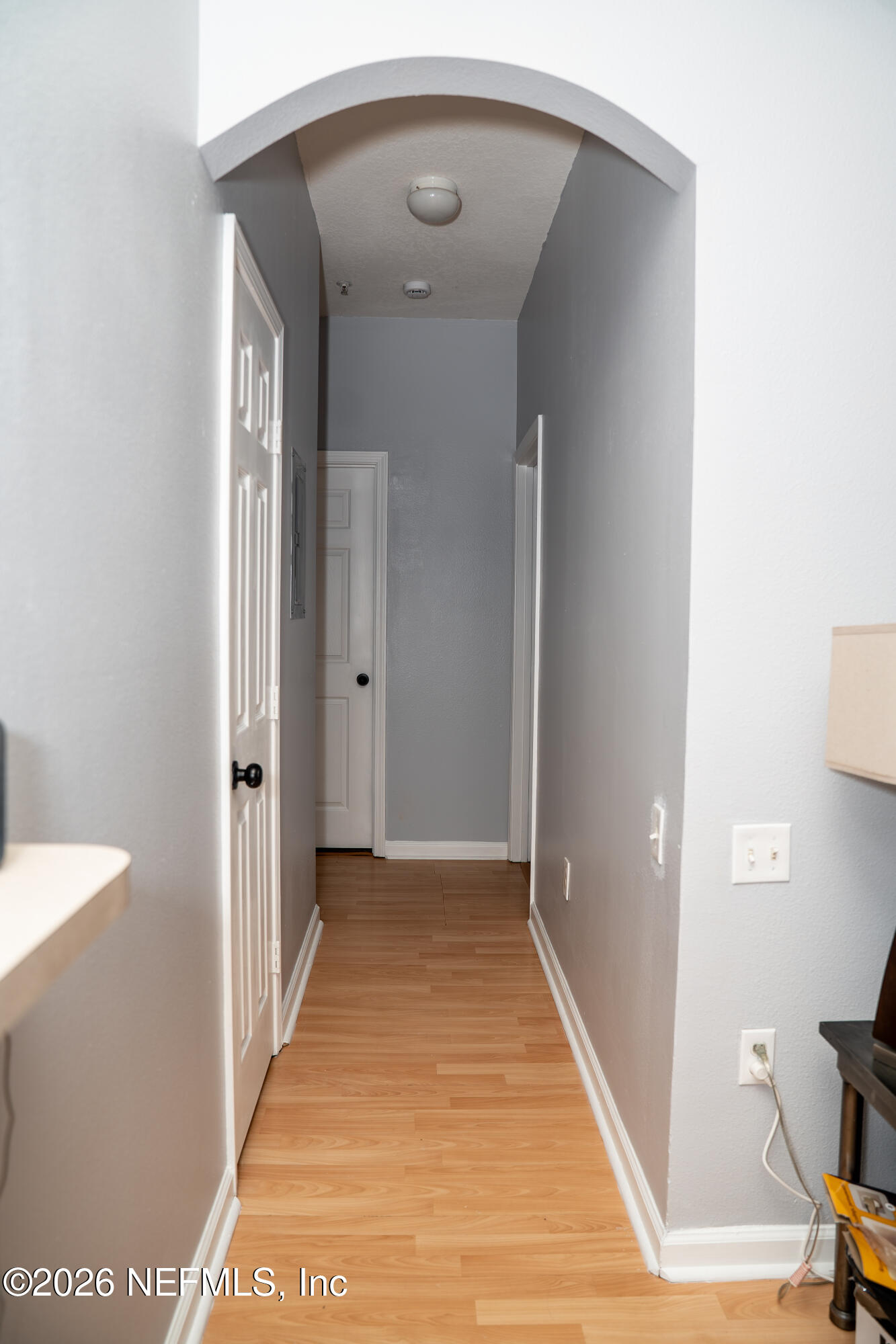 7990 Baymeadows Road East, Unit 530 Jacksonville, FL 32256 - Photo 4 of 19 a view of a hallway with wooden floor and a bathroom