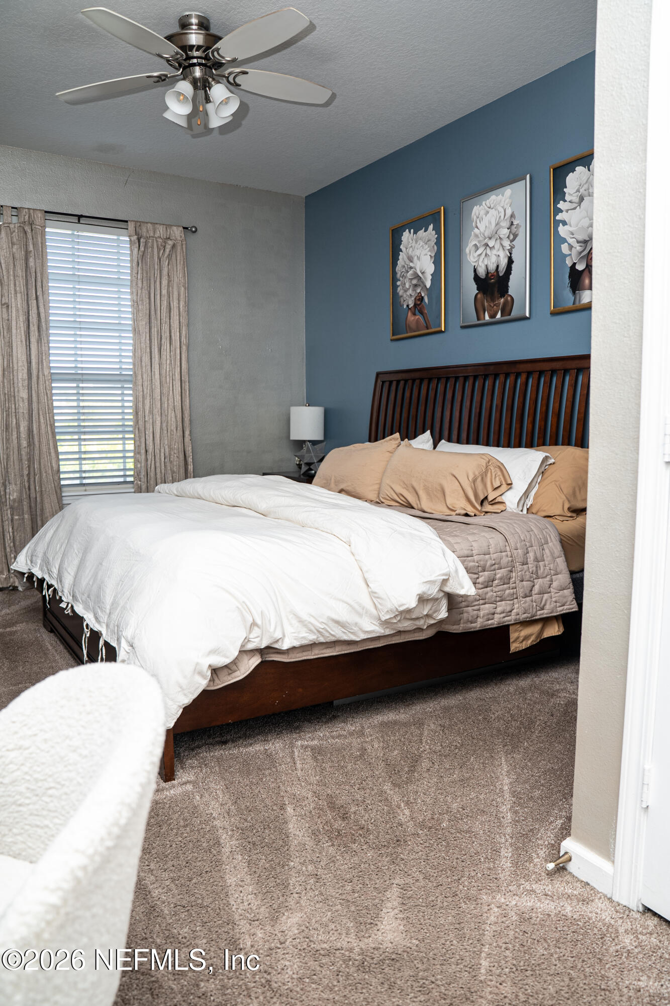 7990 Baymeadows Road East, Unit 530 Jacksonville, FL 32256 - Photo 8 of 19 a bedroom with a large bed and a chandelier