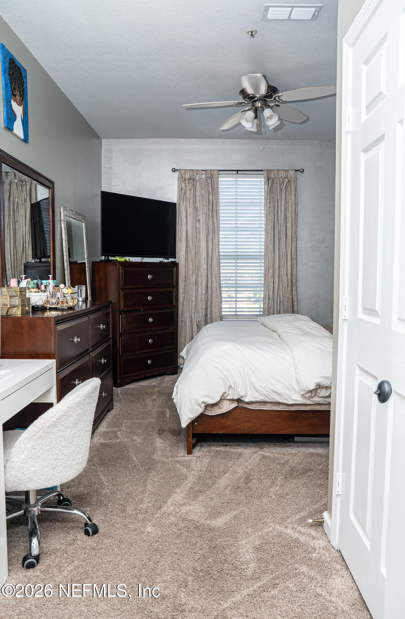 7990 Baymeadows Road East, Unit 530 Jacksonville, FL 32256 - Photo 9 of 19 a bedroom with a bed and a flat screen tv