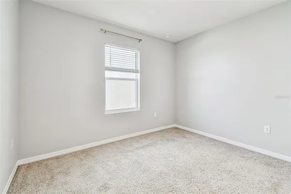 an empty room with white walls