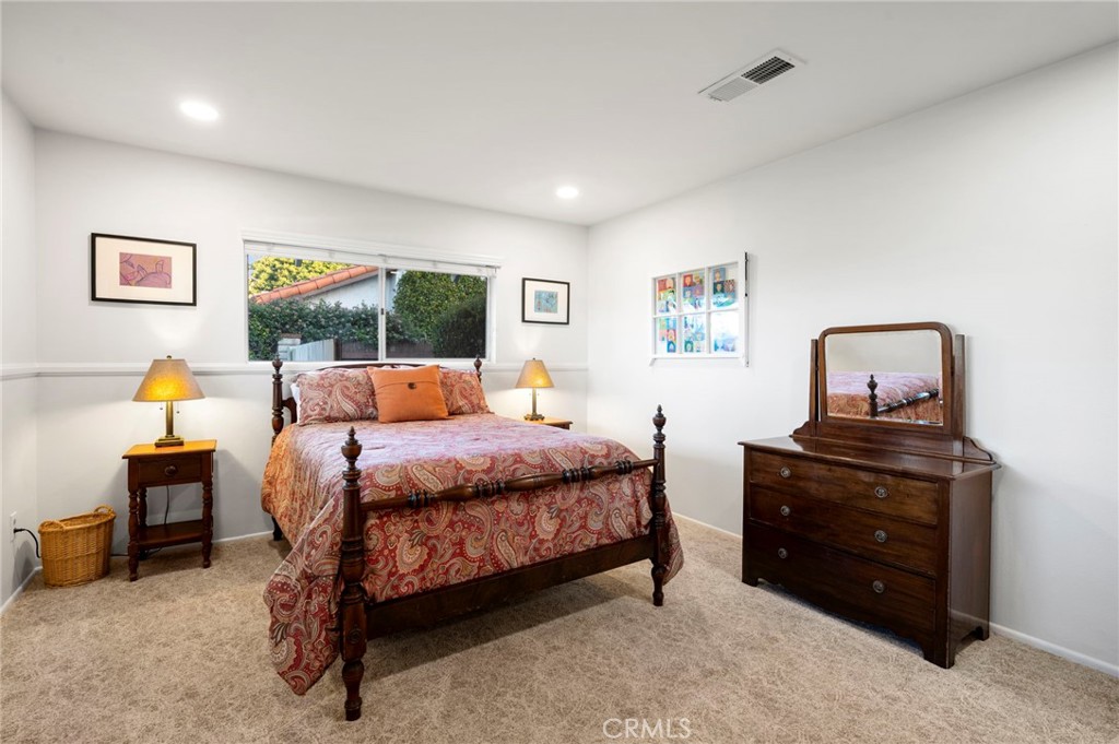 3495 Ridgecrest Drive Carlsbad, CA 92008 - Photo 36 of 42 a bedroom with a bed and wooden floor