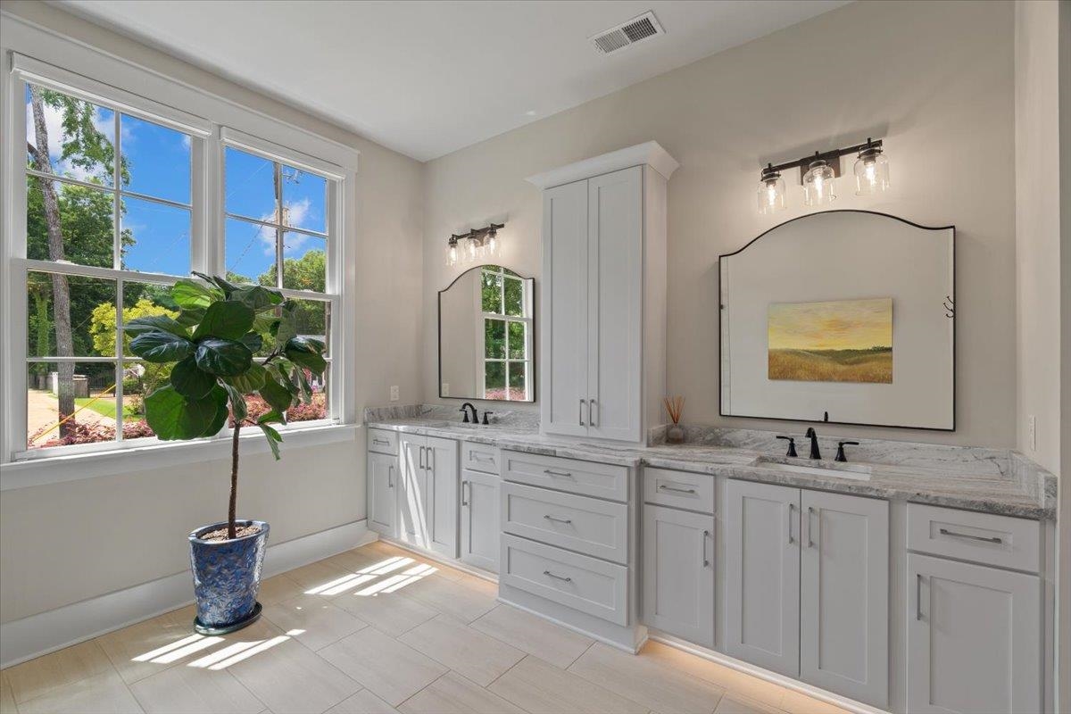 240 Burrows Road Collierville, TN 38017 - Photo 14 of 37 Dual vanity bathroom featuring light-toned cabinetry, undermount sinks, and stone countertops