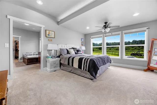 a bedroom with a bed and a large window