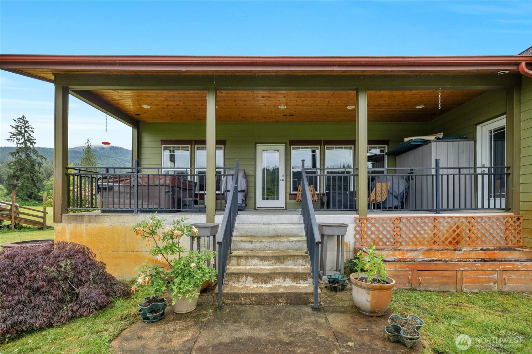 26812 162nd Street Southeast Monroe, WA 98272 - Photo 28 of 40 a view of a patio with table and chairs potted plants and floor to ceiling window