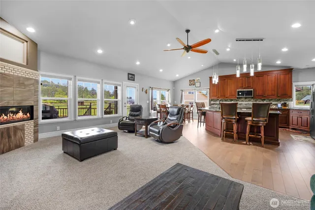 a living room with lots of furniture and kitchen view
