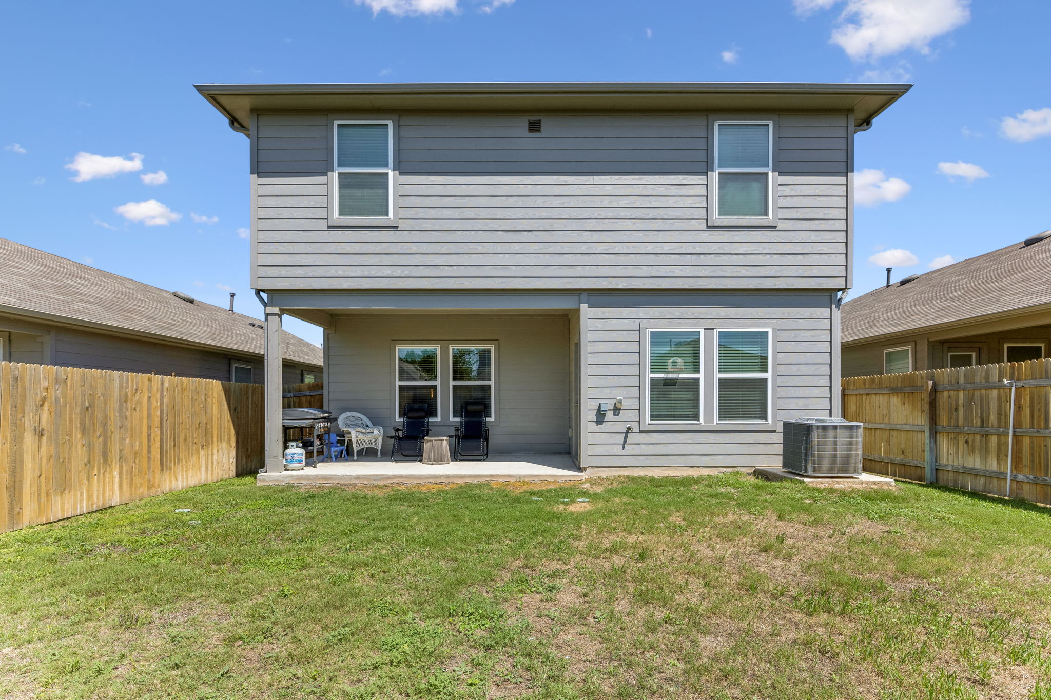 343 Sickle Loop Kyle, TX 78640 - Photo 35 of 40 The rear exterior features a two-story design with horizontal siding