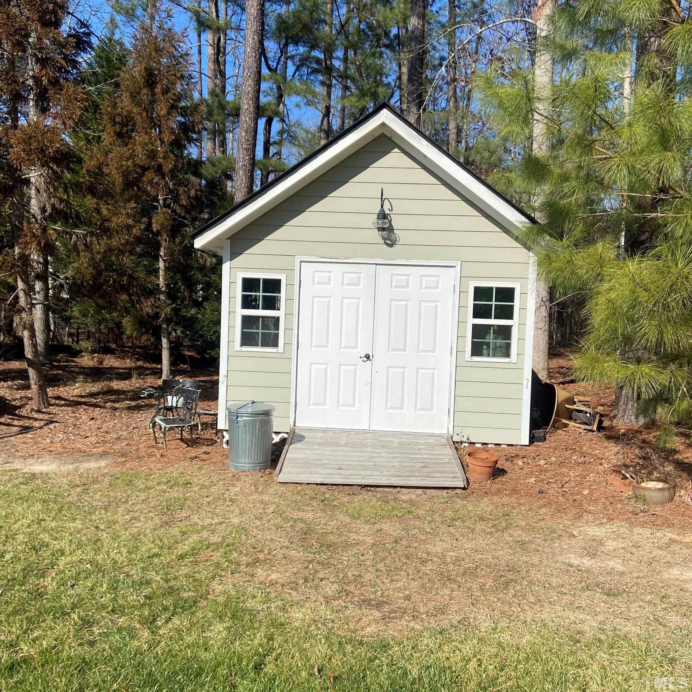 65 Oak Grove Church Road Youngsville, NC 27596 - Photo 5 of 9 a front view of house with yard and trees in the background