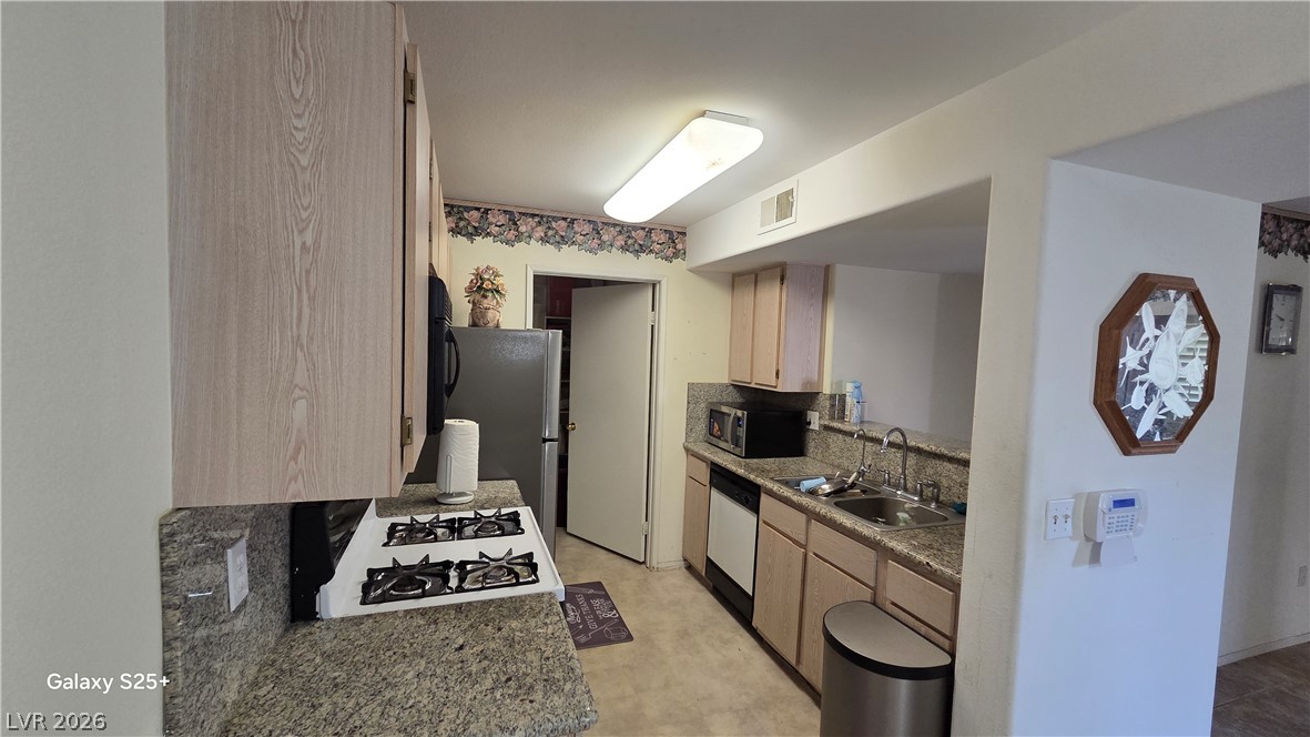 7885 West Flamingo Road, Unit 1008 Las Vegas, NV 89147 - Photo 16 of 29 Functional kitchen with ample counter space and appliances awaits your culinary touch.
