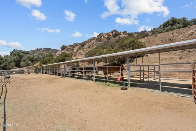 a view of a terrace with furniture and city view