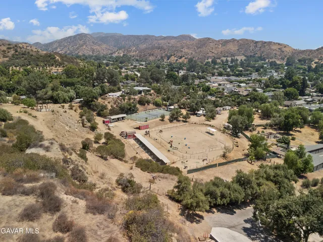 an aerial view of houses with a yard