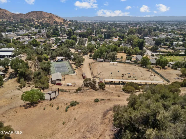an aerial view of a residential houses with outdoor space