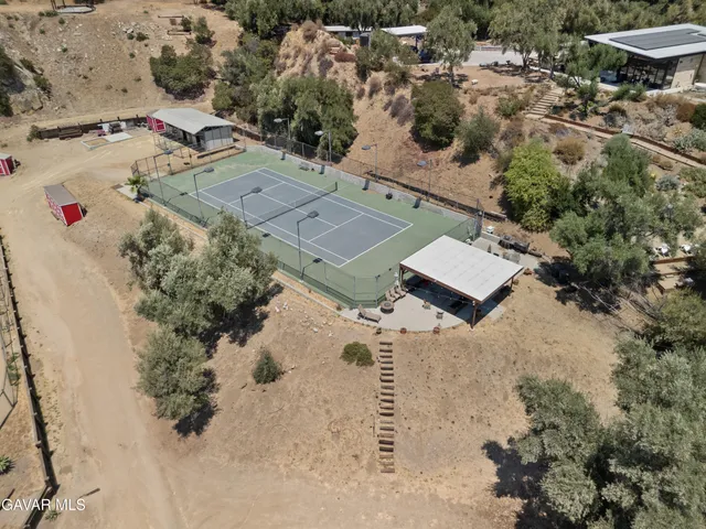 an aerial view of a house with a yard