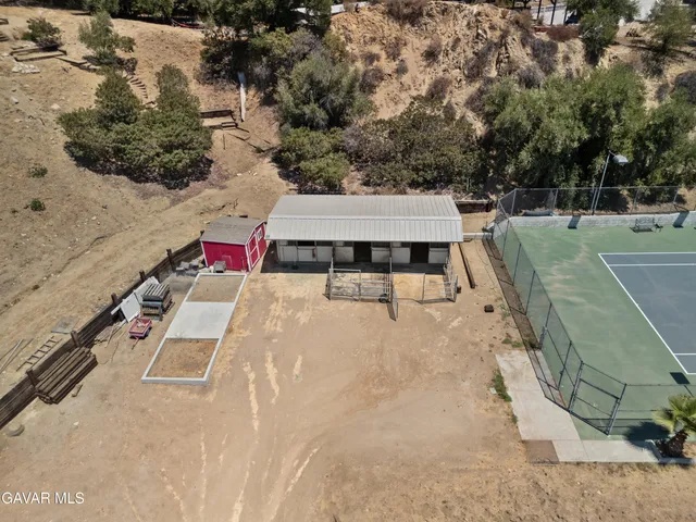 a view of a dry yard with trees