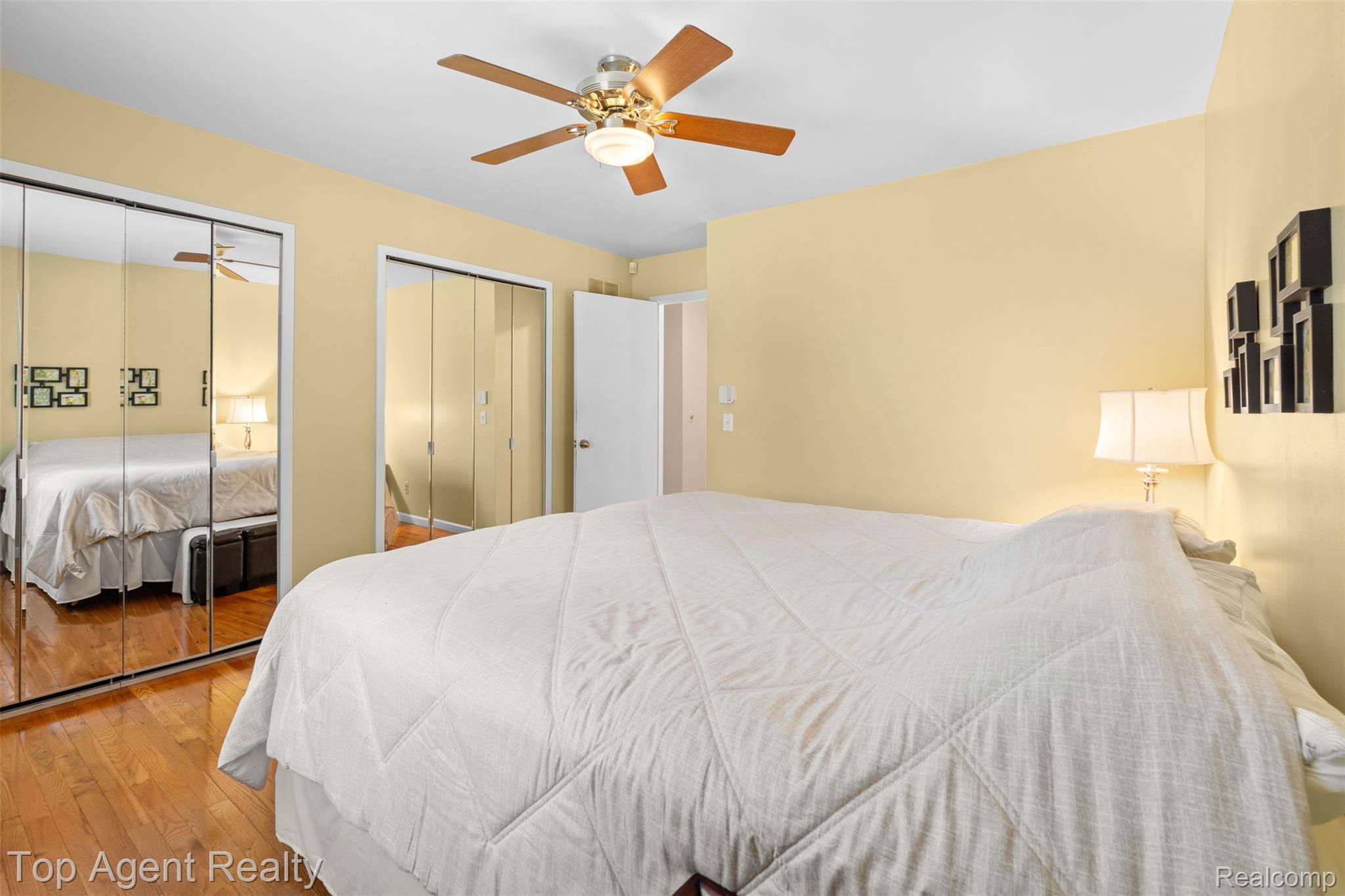 1351 Milverton Road Troy, MI 48083 - Photo 24 of 42 Bedroom with two closets, wood-type flooring, and a ceiling fan