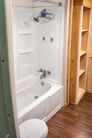 a bathroom with a tub shower and a sink