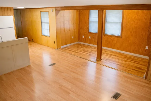 a view of wooden floor and brick walls
