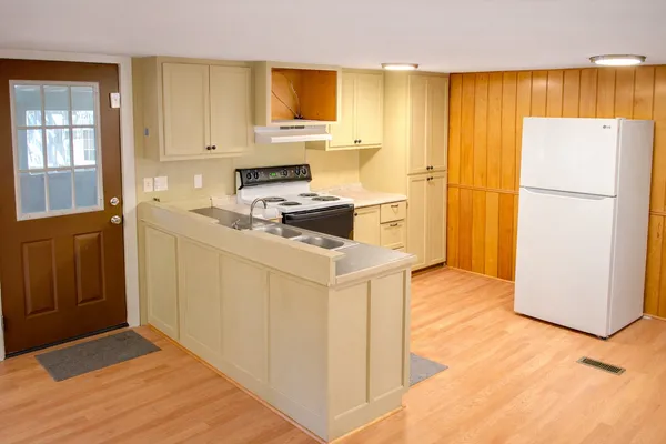 a kitchen with a refrigerator sink and stove