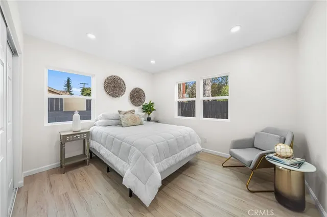 a bedroom with a bed and a large window