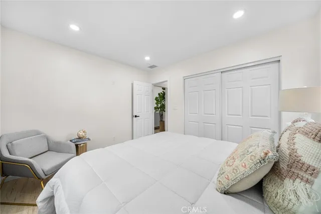 a bedroom with a large bed and a couch