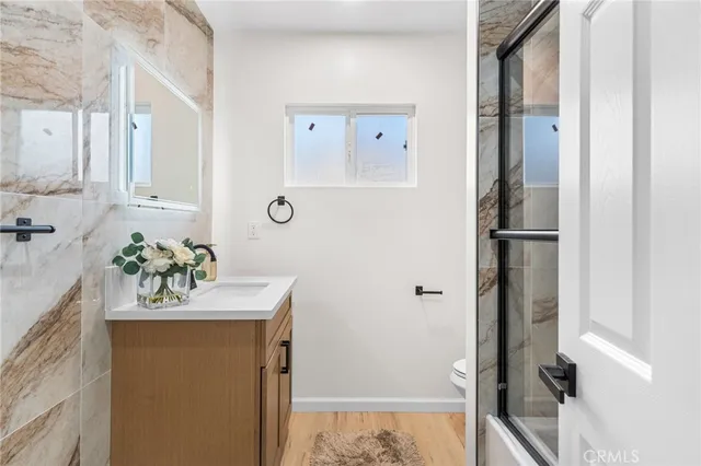 a bathroom with a sink a mirror and a shower