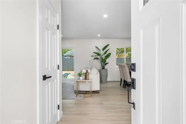 a living room with furniture and a potted plant