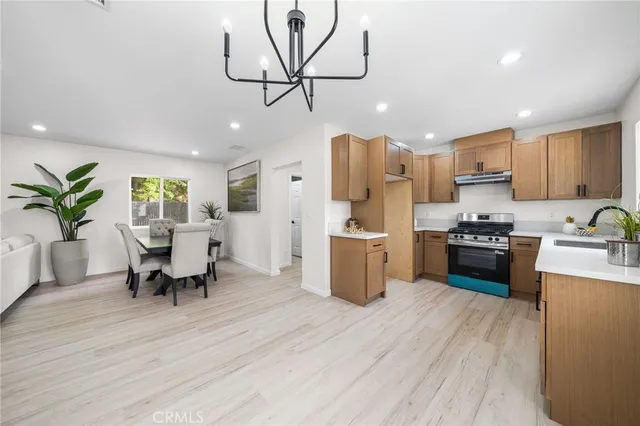 a living room with stainless steel appliances kitchen island granite countertop furniture wooden floor and a window