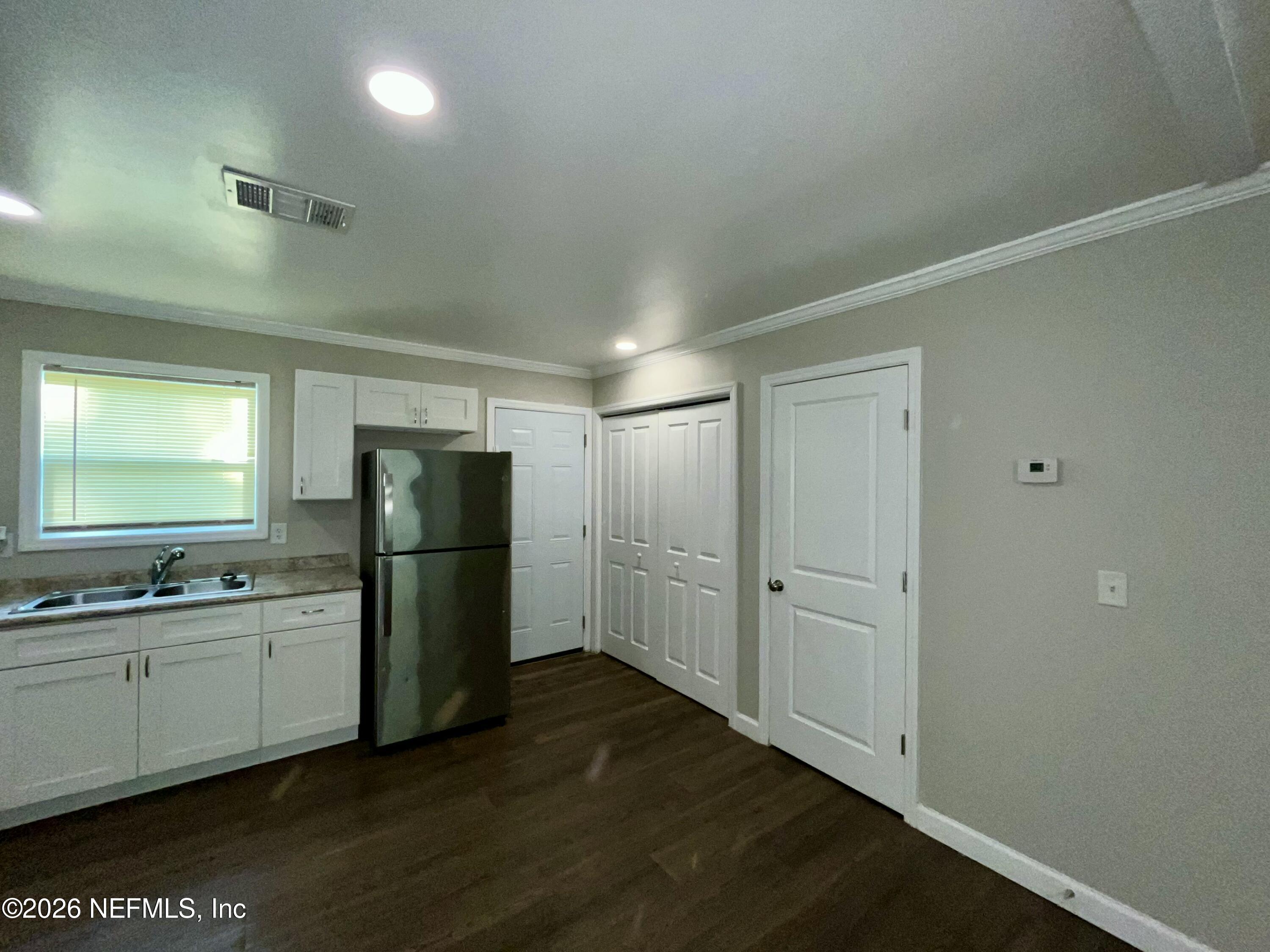 2017 Talladega Road Jacksonville, FL 32209 - Photo 18 of 34 a view of a kitchen with a sink and a refrigerator